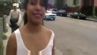 Confident woman entertains public with seductive striptease.