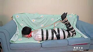 Asian beauty bound and gagged in BDSM play